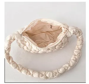 Interior view of the cream quilted cloud bag showing the zip pocket and soft lining