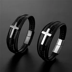 Detail of multi-layer black leather bracelets with black and silver metal cross charms