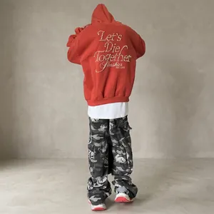 Red hooded sweatshirt with Let's Die Together pearl lettering and dropped shoulders