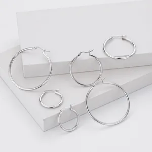 Close-up of various sized S925 sterling silver smooth hoop earrings on display blocks.