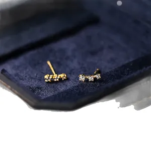 Elegant minimalist S925 silver meteor zircon stud earrings in gold finish on velvet