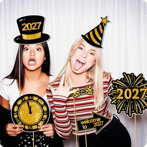 Models posing with 2027 New Year's Eve party photo booth props in gold and black