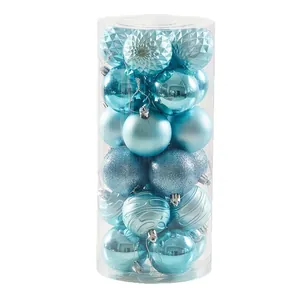 Set of blue Christmas ball ornaments with varied textures in a clear storage tube