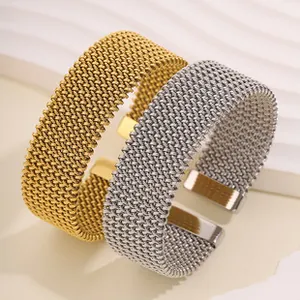 Detailed close-up of gold and silver mesh woven titanium steel cuff bracelets.