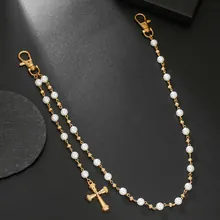 Detail view of a punk hip-hop double waist chain with gold cross and white pearls.