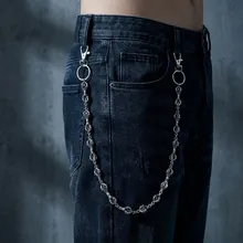 Detailed view of a silver punk hip hop metal waist chain worn on dark denim jeans