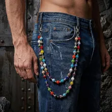Detail of double-layered hip hop waist chain with colorful beads on denim jeans