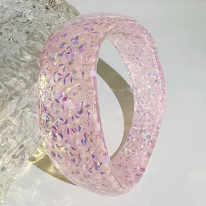 Detailed close-up of pink translucent resin bangle with shimmering iridescent flakes