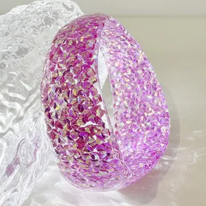 Close-up of a purple resin bangle bracelet with sparkling iridescent glitter flakes
