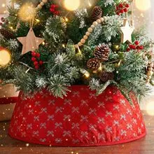 Detailed view of red Christmas tree skirt with bow patterns under festive tree
