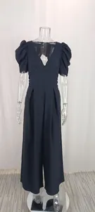 Detail of black wide-leg jumpsuit featuring V-neck and puff sleeves on mannequin.
