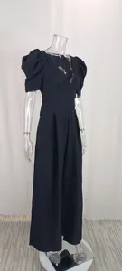 Elegant black V-neck jumpsuit with puff sleeves and wide legs displayed on a mannequin