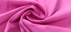 Macro detail of high quality vibrant fuchsia fabric used in a solid color jumpsuit