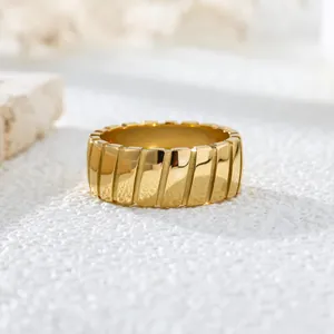 Close-up detail of vintage gold plated titanium steel ring with slanted line texture