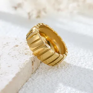 Close-up macro shot of gold stainless steel ring featuring retro slanted line texture details