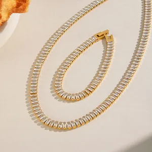 Detailed view of a golden stainless steel jewelry set with square zircon stones.