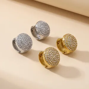 Gros plan détaillé de boucles d'oreilles créoles en acier doré et argenté avec strass