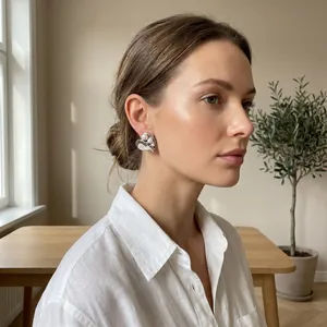 Close-up of elegant French style heart-shaped asymmetrical earrings with pearl inlay.