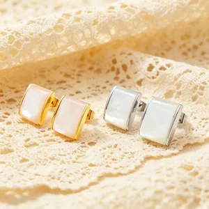 Close-up of stainless steel quadrilateral earrings with elegant pink and white shell inlays.