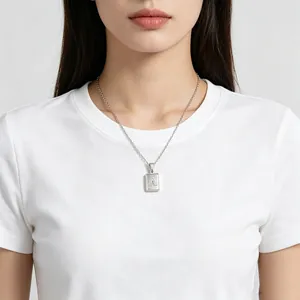 Minimalist stainless steel square pendant necklace with capital letter A on a model