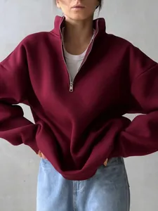 Oversized burgundy fleece half-zip sweatshirt with stand collar and ribbed cuffs