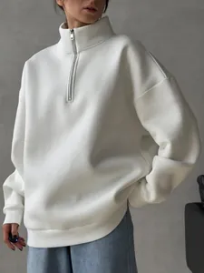 Detail of white oversized fleece sweatshirt with high collar and silver metal zipper