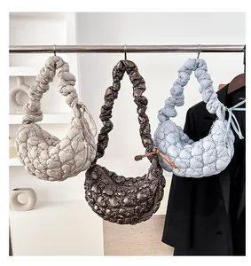 Three quilted heart pattern cloud bags in cream, metallic brown and blue colors
