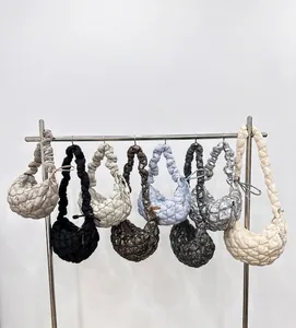 Detailed display of seven color variations for pleated cloud hobo bags on a hanger