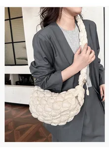 Detail of quilted cloud bag showing the puffy bubble texture and wide shoulder strap