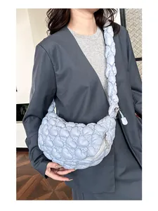 Close-up of light blue quilted cloud bag showing bubble texture and pleated strap