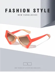 Close-up of coral orange gradient butterfly sunglasses with modern geometric frame and lenses