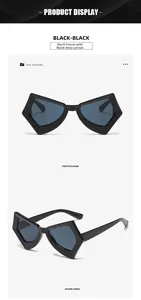 Detail view of butterfly frame sunglasses with black frame and black gray lenses
