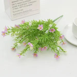 Artificial jasmine and wildflower bouquet with green leaves in a home decor setting