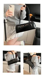 Detail shots of a vintage black long baguette bag with thin handles and double zippers