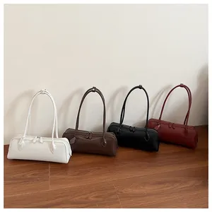Modern minimalist cylinder shoulder bags in cream, mocha, black, and burgundy leather