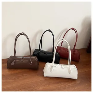 Various colors of retro long handle baguette bags displayed on a wooden floor