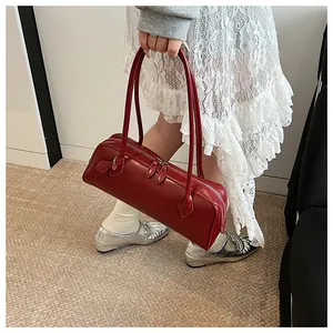 Top view of deep red leather baguette bag with dual zippers and long handles