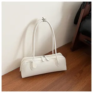 Detail of white PU leather baguette bag with double zipper and long handle straps