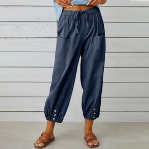 Dettaglio dei pantaloni capri a gamba larga in cotone e lino blu navy a vita alta.