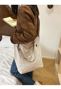 Large cream canvas tote bag styled with a vintage brown plaid jacket and blue jeans