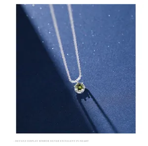 Macro detail of s925 silver necklace featuring a brilliant sparkling olive green zircon