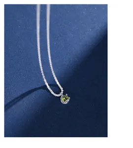 Detailed view of the olive green zircon pendant on a polished S925 silver chain necklace