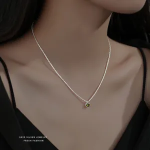 S925 sterling silver necklace with a sparkling green zircon pendant on a model