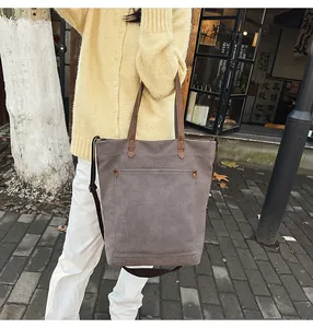 Grey canvas tote bag with adjustable shoulder strap and large front pocket detail