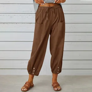 Women's stylish high waist cotton linen cropped pants in brown with button details.