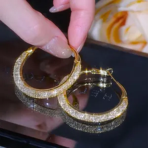 Elegant close-up of gold-plated large hoop earrings featuring sparkling pave-set stones