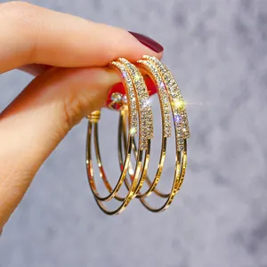 Detailed macro view of gold hoop earrings encrusted with sparkling cubic zirconia