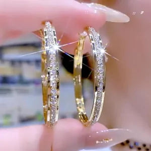 Detailed view of luxury gold-plated large hoop earrings featuring sparkling inlaid zircon stones