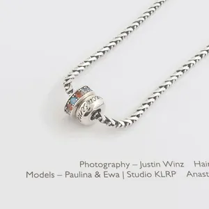 Elegant S925 sterling silver rainbow bead bracelet on stylish magazine background