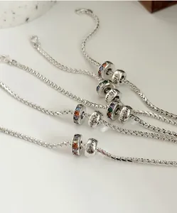 Macro detail of S925 sterling silver bracelet with rainbow stones and lucky beads